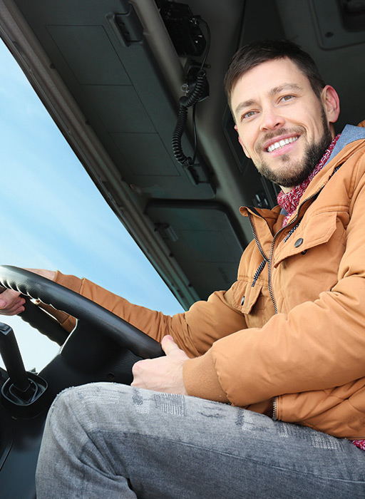 Red semi driving with wood products