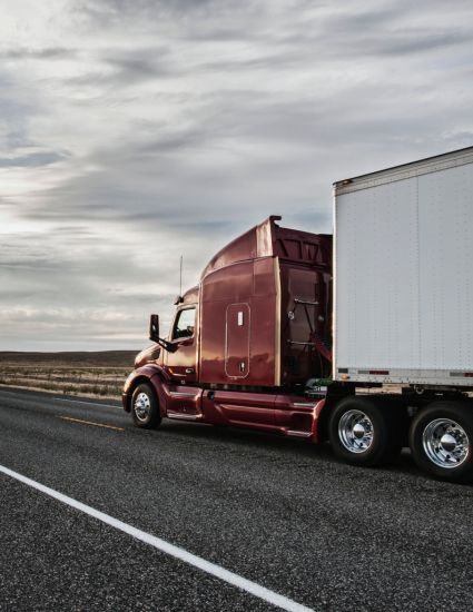 Truck driving down two lane road.